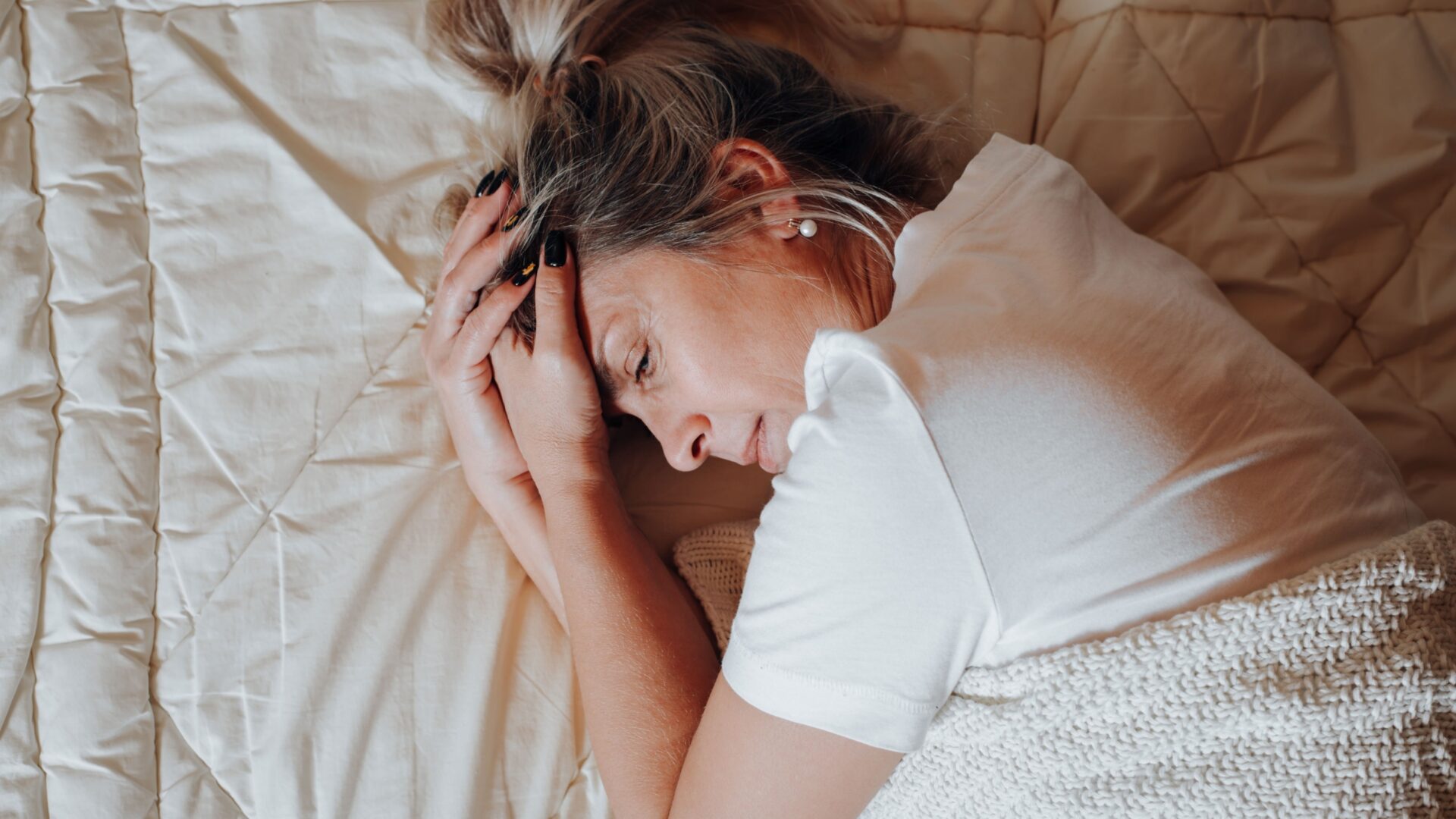 Vrouw opgekruld op bed