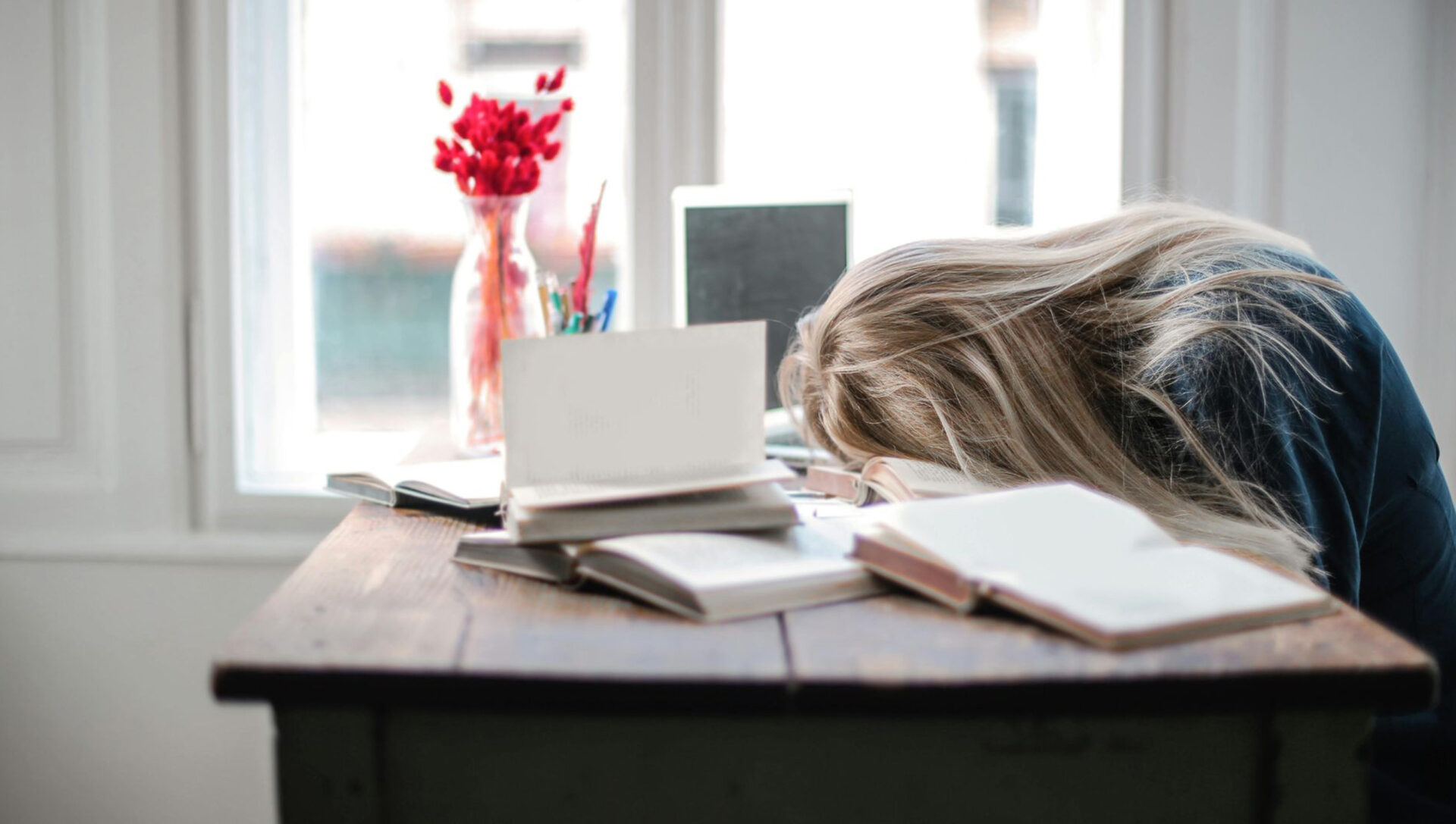 Vrouw ligt met haar gezicht op tafel